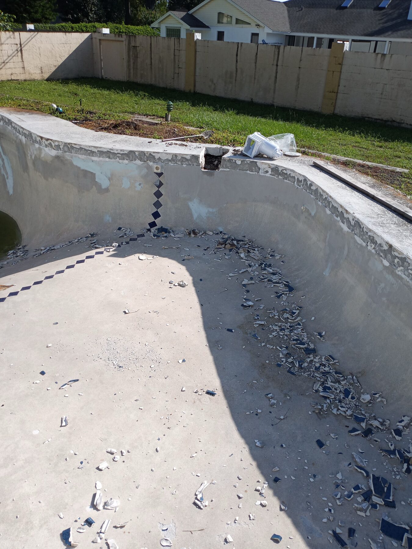 Orlando pool chip-out close-up showing exposed shell and waterline tile preparation